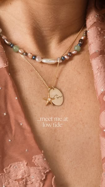 A close up view of a woman wearing a pearl necklace, and gold pendant necklace with the text overlay of "meet me at