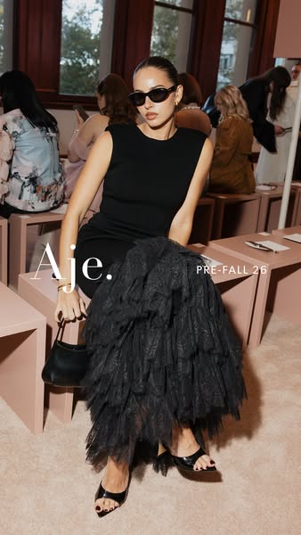 This ad features a photo of a model in a black dress, promoting the brand Aje.