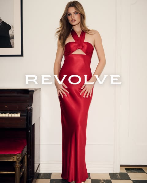 This ad showcases a model wearing a red evening gown, intended for an audience interested in luxury fashion and special 