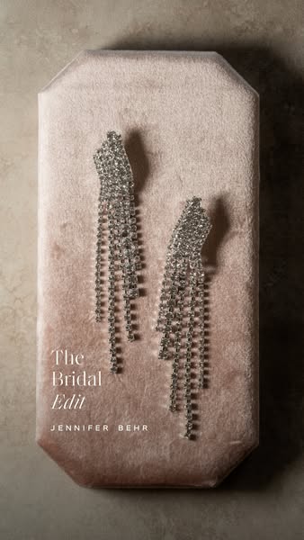 This ad features a pair of Jennifer Behr earrings from "The Bridal Edit" collection. The earrings are showcase