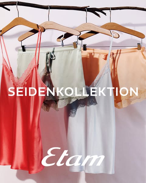 This ad displays silk pajama sets from Etam. Three pajama sets are on wooden hangers hanging from a branch.