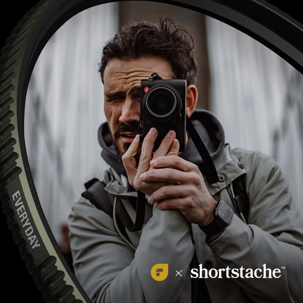 An image showcasing a bicycle tire in partnership with Shortstache, positioned in the foreground, with a photographer in