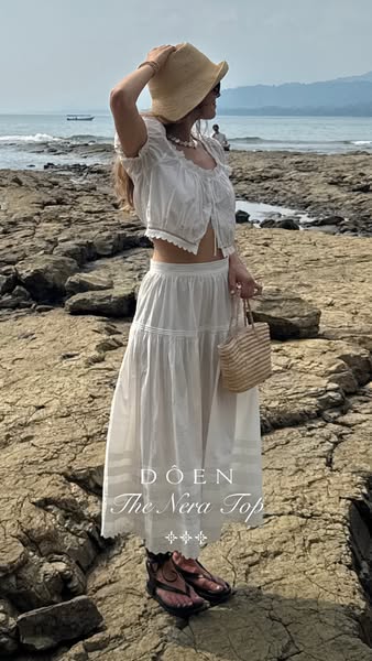 An outdoor shot of a model wearing the DÔEN brand Nera top.