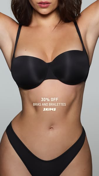 This image ad from SKIMS promotes 30% off bras and bralettes. The model is wearing a black bra and underwear set from th