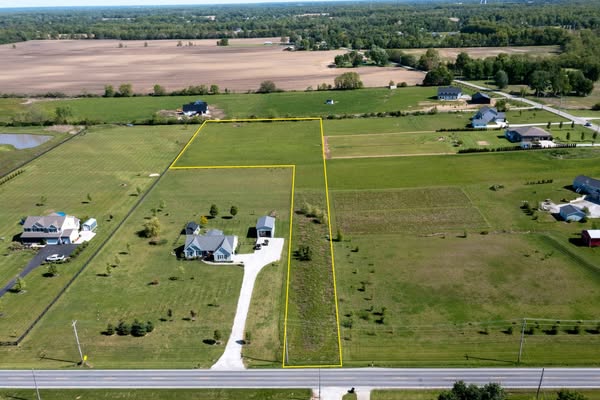 This ad showcases an aerial shot of a plot of land available for purchase. The land is outlined in yellow and is located