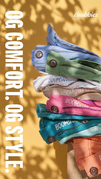 Ad showcasing different colors of Chummbies shorts stacked on top of each other with a shadow of a leaf pattern in the b