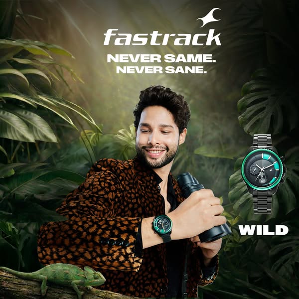 This ad for Fastrack watches features a man in an animal print jacket holding binoculars in a jungle-like setting, juxta