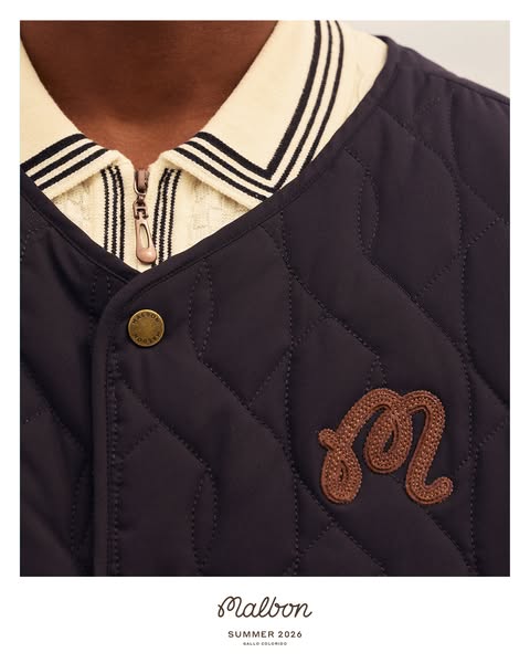 The ad features a close-up of a quilted Malbon jacket with the brand's logo, set against a clean white background. T