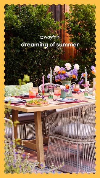 This image ad showcases a Wayfair patio set arranged on a wooden deck in a lush outdoor setting, suggesting an idyllic s