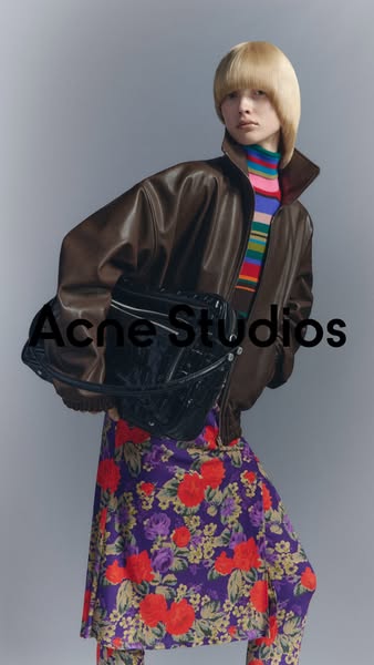 This ad features a person wearing a brown leather jacket, a colorful striped turtleneck, a floral dress and leggings, an