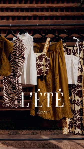 This image ad from Sézane presents a rack of summer clothing in a warm, inviting style.
