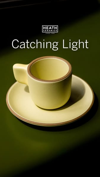 This ad showcases a ceramic mug and saucer from Heath Ceramics. It uses a simple, elegant visual approach.