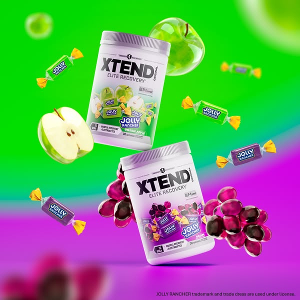 This ad features Xtend Elite Recovery supplement powder in Green Apple and Grape flavors, alongside fresh fruit and Joll