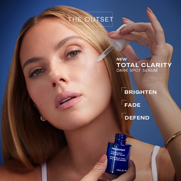 This image ad for The Outset Total Clarity Dark Spot Serum features a woman applying the product to her face. The ad hig