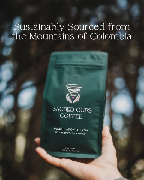 The ad features a hand holding a bag of Sacred Cups Coffee with the headline: 'Sustainably Sourced from the Mountain
