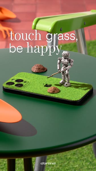 This ad promotes a phone case from dbrand that looks like grass. The visual features a phone with the case on a green ta