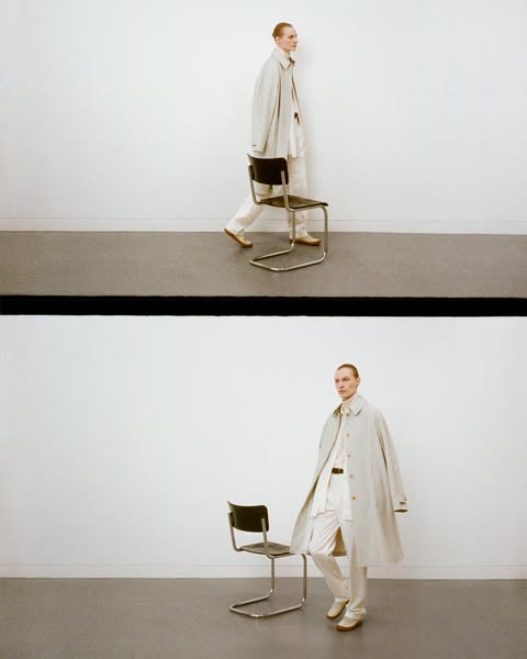 This ad features a person wearing a light-colored trench coat, white pants, and a white shirt. The person is standing ne