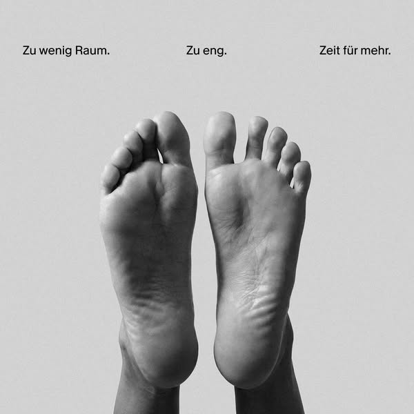 This black and white image ad uses a picture of a pair of feet to demonstrate the need for more space. The top caption r