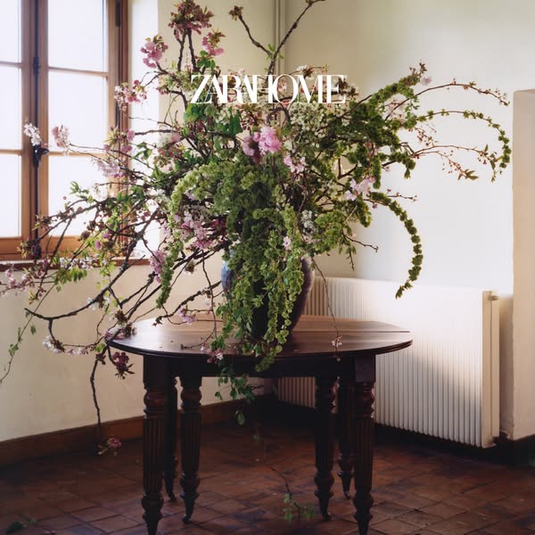 This Zara Home ad features a lush, artfully arranged floral display in a rustic interior. The photo emphasizes the beaut