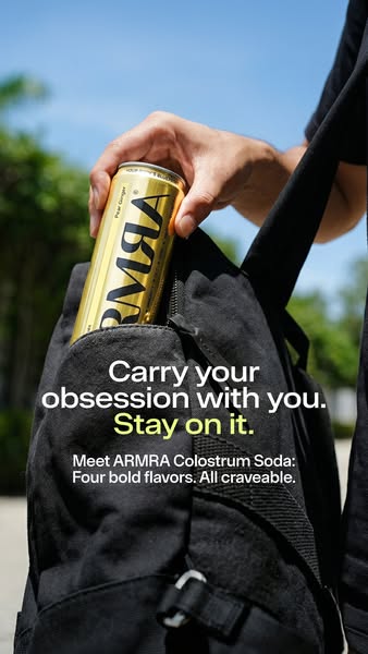 This ad features a can of ARMRA Colostrum Soda being placed in a black backpack. The ad encourages the viewer to carry t
