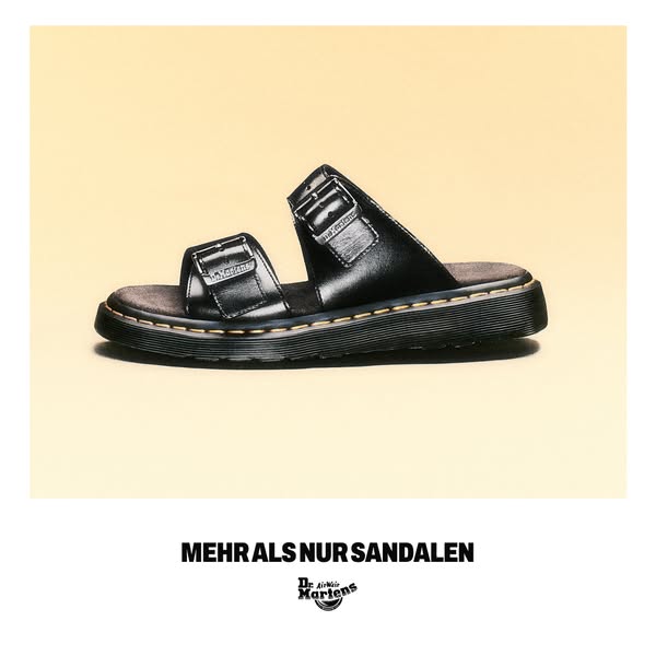 This ad showcases a pair of black Dr. Martens sandals on a light yellow backdrop. The headline states that they are '