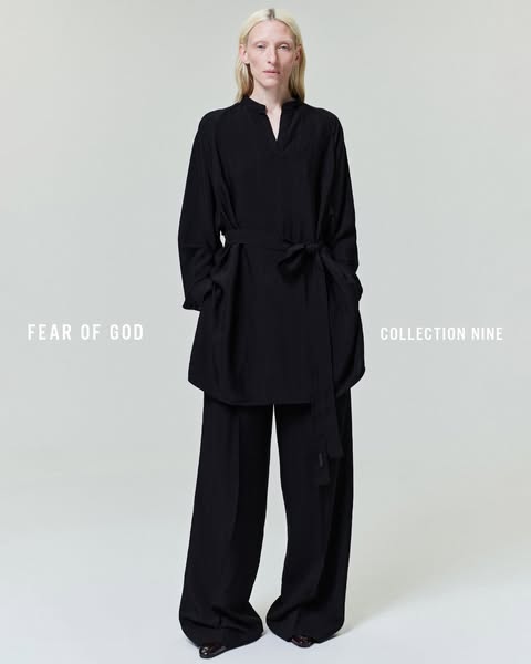 A woman stands wearing a black outfit from the brand Fear of God’s Collection Nine.