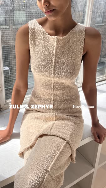 This ad showcases a knitted dress from Zulu & Zephyr's new collection. The image presents the dress on a model p