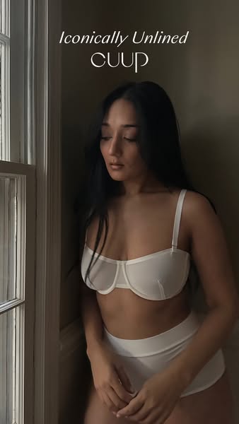 This ad features a woman wearing a CUUP bra and underwear set. The ad highlights the unlined design of the bra and the b