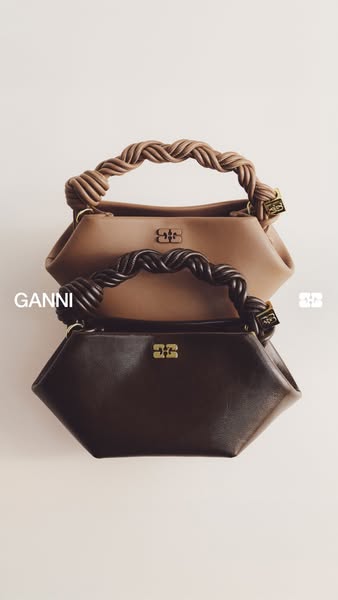 This ad features two Ganni handbags stacked on top of one another against a neutral background. The focus is on the desi