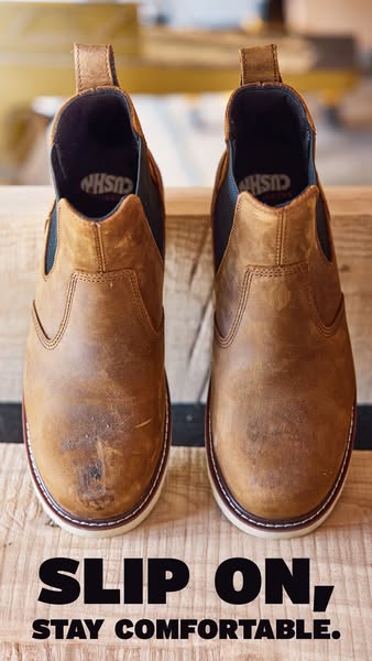 The image is a close up of two brown, leather boots sitting on top of a wood surface. The text at the bottom of the imag