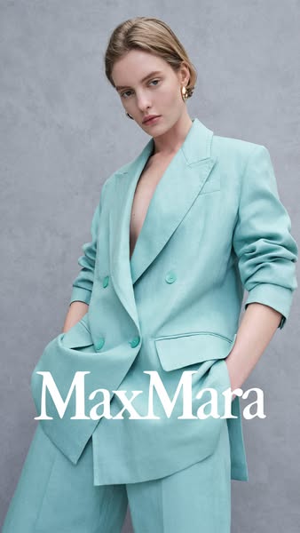 This ad features a fashionable light blue double breasted suit by Max Mara, designed to resonate with a modern, sophisti