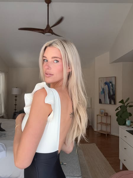 This image ad features a woman wearing a white and black bodysuit in what looks like her home. The ad seems to be target