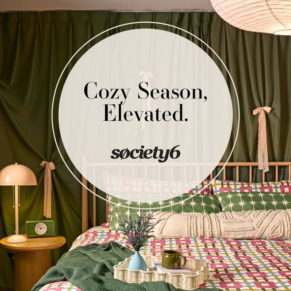 The ad features a cozy bedroom setup with Society6 bedding and decor, emphasizing comfort and style for the fall season.