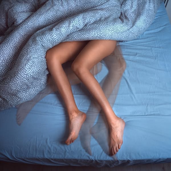 This ad shows a woman in bed and uses that visual to connect the idea of restless leg syndrome with a solution for the p