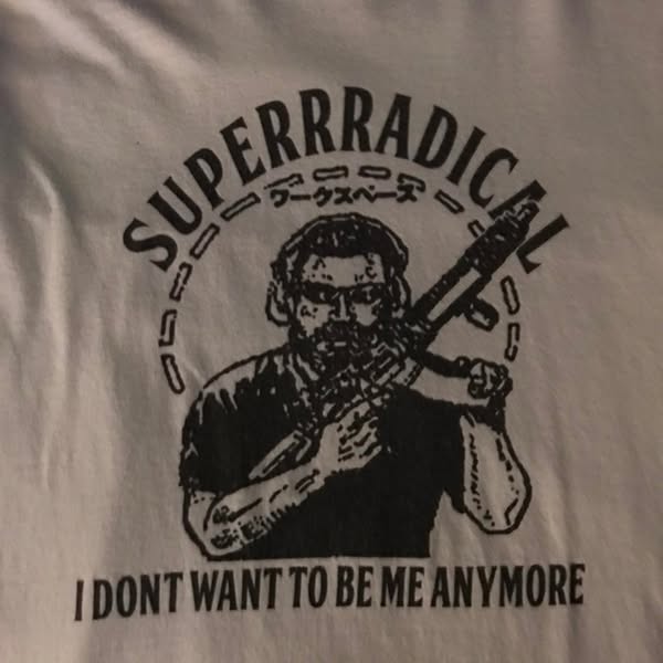 This ad shows an image of a t-shirt with a black and white graphic featuring a person holding a gun and the text "S