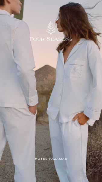 This image ad showcases Four Seasons Hotel Pajamas, featuring a couple in white pajamas in a desert setting.