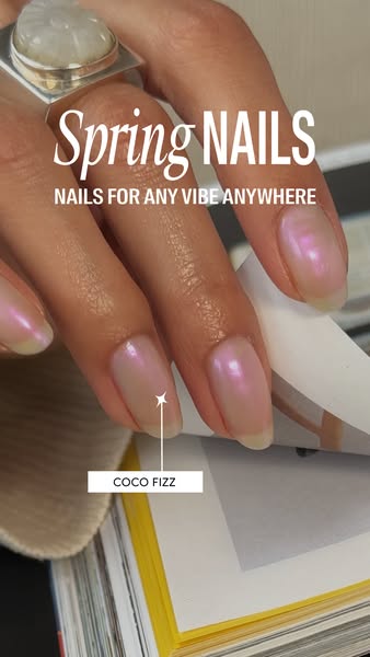 This image ad showcases a hand with pearlescent nails over a book. The text highlights 'Spring Nails' suitable &