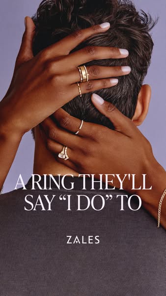 This image ad for Zales features a close-up of a man's neck and the back of his head. A woman's hand, adorned wi