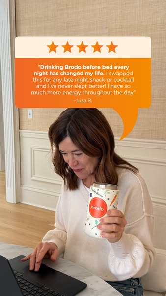 An image ad featuring a woman using a laptop at a marble table with a can of Brodo in a decorative sleeve. The ad featur