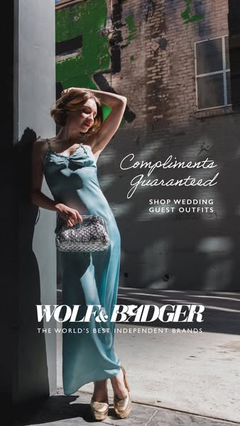 This image ad is for Wolf & Badger. The ad features a model wearing a blue dress next to a building.