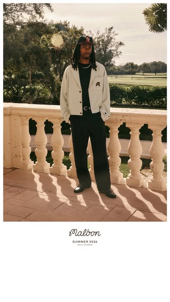 This Malbon clothing ad features a model wearing a beige jacket and black slacks while standing on a balcony with a golf