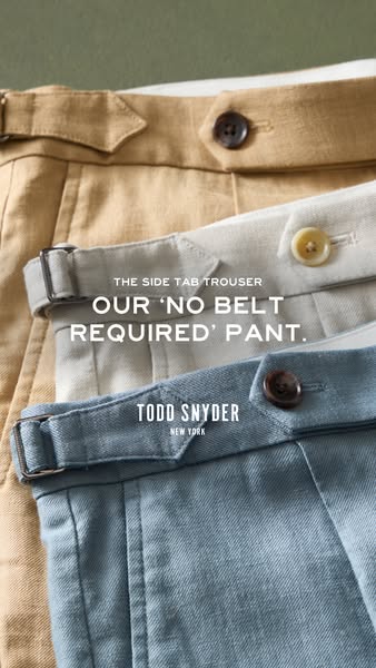 A close-up shot of three pairs of Todd Snyder side-tab trousers in varying colors (tan, off-white, and light blue) are s