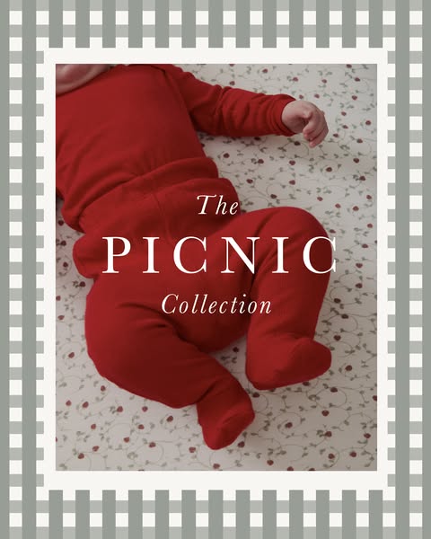 An advertisement for “The Picnic Collection” showcasing baby clothes. The baby is pictured on a sheet with flowers and t