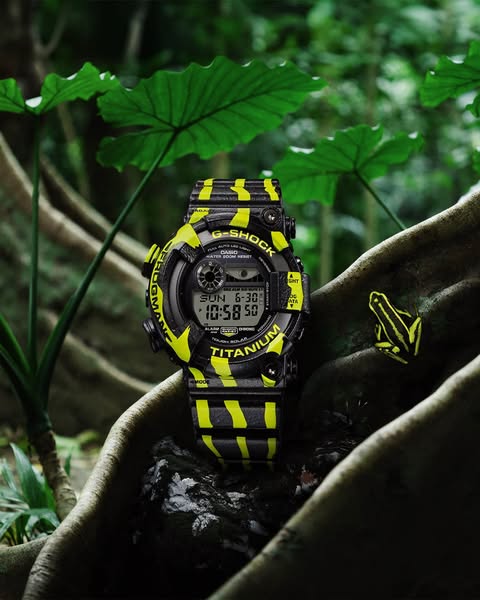 This image ad showcases a G-Shock watch with a yellow and black striped design, reminiscent of a frog pattern, in a lush