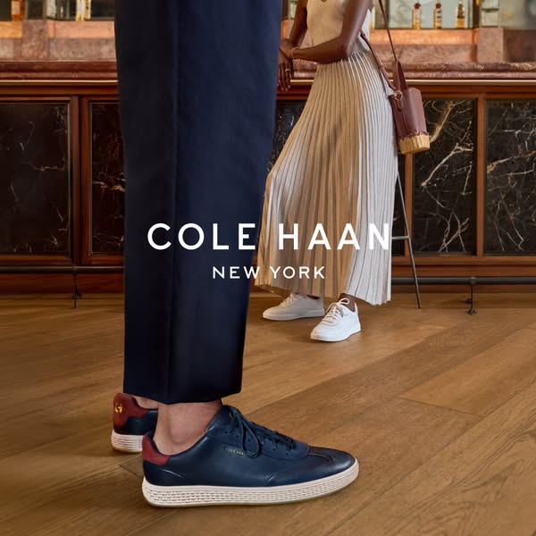 An advertisement showcasing Cole Haan shoes. Two people are present, wearing different styles of Cole Haan shoes. The ov
