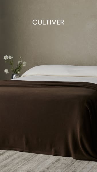 This ad features a close-up of a bed with a dark brown Cultiver brand blanket draped over it. The ad highlights the qual