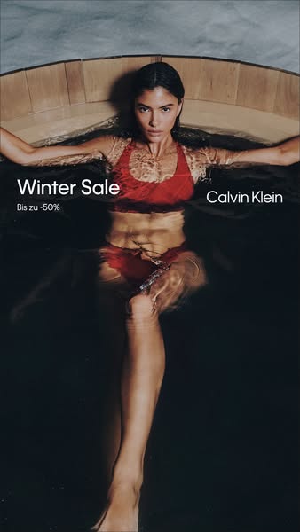 This ad for Calvin Klein features a woman in a pool wearing a red bikini. The ad promotes a winter sale.