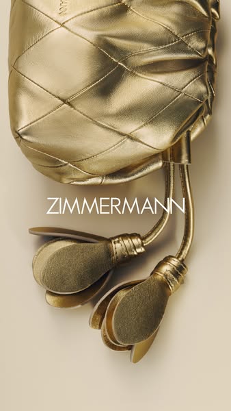 This ad showcases a gold handbag from ZIMMERMANN. The image focuses on the craftsmanship and design of the accessory.