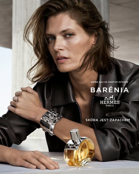 This ad features a model with neutral makeup wearing a black jacket and a silver bracelet next to the product, which is 