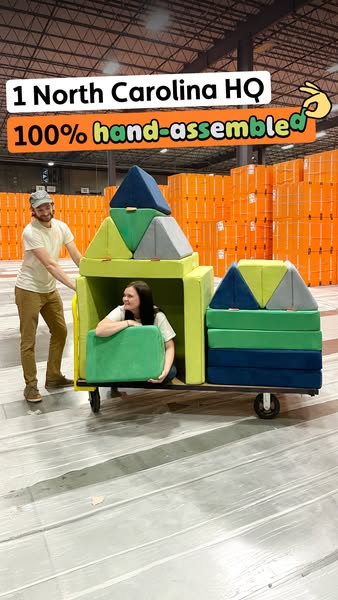 This ad features a man pushing a foam block structure on wheels with a woman inside. The ad copy highlights the handmade